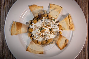 Oriental recipe aubergine and chickpea fatteh, pita, Greek yogurt, roasted pine nuts, zaatar