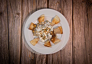 Oriental recipe aubergine and chickpea fatteh, pita, Greek yogurt, roasted pine nuts, zaatar