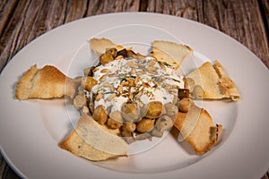 Oriental recipe aubergine and chickpea fatteh, pita, Greek yogurt, roasted pine nuts, zaatar