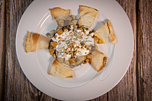 Oriental recipe aubergine and chickpea fatteh, pita, Greek yogurt, roasted pine nuts, zaatar