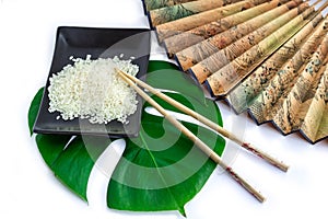 Oriental set of rice, chopsticks, green leaf and transp