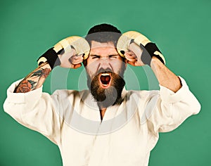 Oriental sports concept. Karate man with mad face in uniform