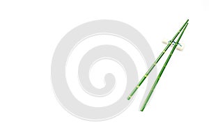 Oriental table set up with bamboo sticks on white background top view space for text