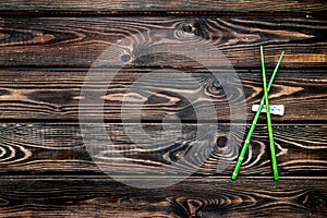 Oriental table set up with bamboo sticks on wooden background top view space for text