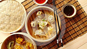 Oriental traditional chinese dumplings served in the wooden steamer