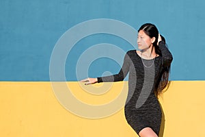 Oriental woman posing on a colorful background