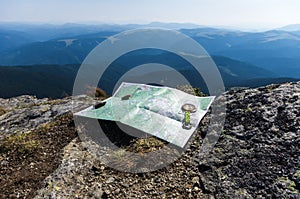 Orientation on the ground. Tourist map and compass.