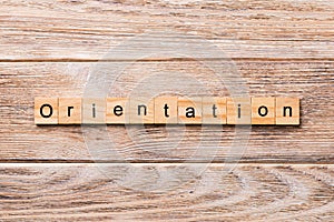 Orientation word written on wood block. Orientation text on wooden table for your desing, concept