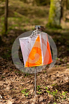Orienteering. Control point Prism and electric composter for orienteering in the spring forest