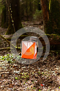 Orienteering. Control point Prism and electric composter for orienteering in the spring forest