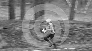 Orienteering. Motion blur. A young girl athlete with a sports card in his hand quickly runs along the orienteering course in the