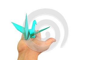 Origami bird flying on people hand on white background