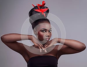 Origami bird, portrait and black woman in studio isolated on gray background with makeup for aesthetic. Glow, creative