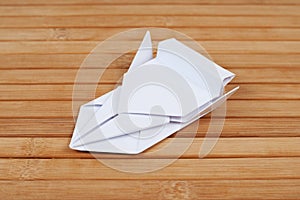 Origami car model on wood. Vehicle figurine made of folded paper. Art exposition item. Racing car from paper