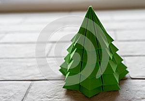 Origami christmas tree made of green paper