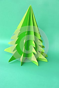 Origami Christmas tree paper on green background