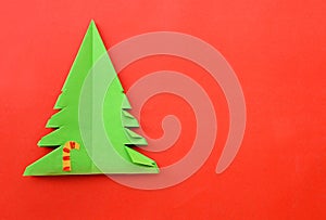 Origami Christmas tree paper on red background