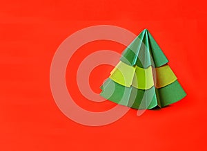 Origami Christmas tree paper on red background