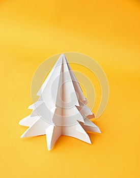 Origami Christmas tree paper on yellow background