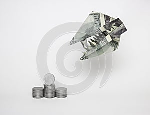 An origami figure of dollars in the form of an animal`s head with teeth and a ruble coin. The concept of the growth of the dollar