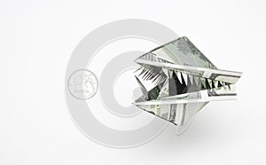 An origami figure of dollars in the form of an animal`s head with teeth and a ruble coin. The concept of the growth of the dollar