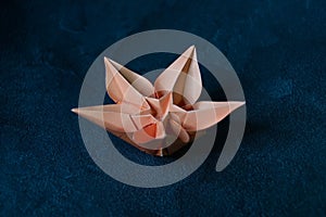 Origami Flower Blossom - Paper Art on Textured Background