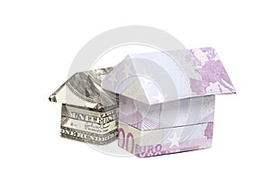 Origami house made of 500 euro and 100 dollar banknotes