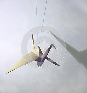 Origami japanese crane with shadow on the wall. abstract background for your design