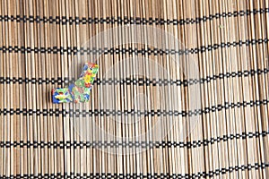 Origami ribbon decoration on a bamboo mat