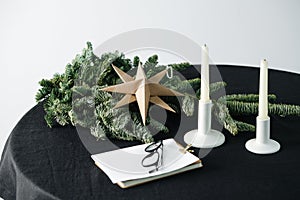 Origami star, artificial tree on a round table with a black tablecloth