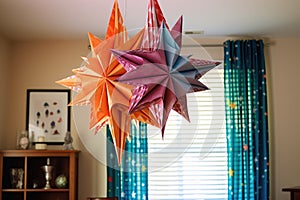 origami star mobile hanging from the ceiling