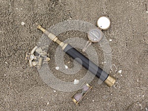 Original background with compass and telescope on the sand