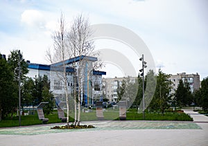 Original benches  in the Geologists ` Square in the city of Noyabrsk in summer
