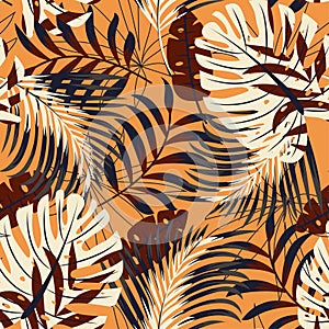 Original bright seamless pattern with colorful tropical leaves and plants on orange background. Vector design. Jungle print. Flora