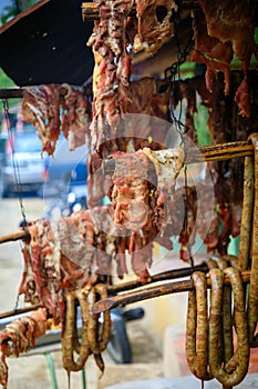 Original Caribbean food on the roadside in the Dominican Republic. Smoked pork, morcillas and longanizas.