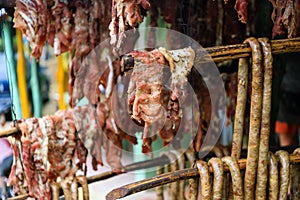 Original Caribbean food on the roadside in the Dominican Republic. Smoked pork, morcillas and longanizas.