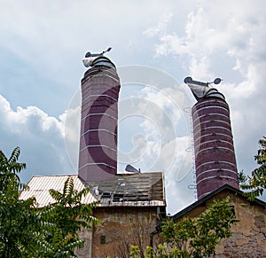 Original chimneys of an old brewery against the blue sky. The old building of the brewery in the city of Nitra, Slovakia