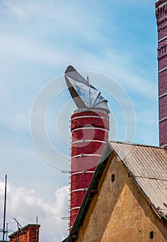 Original chimneys of an old brewery against the blue sky. The old building of the brewery in the city of Nitra, Slovakia