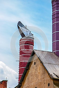 Original chimneys of an old brewery against the blue sky. The old building of the brewery in the city of Nitra, Slovakia