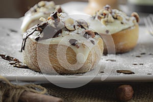 Original cinnabon rolls with chocolate-cream sauce and hazelnuts