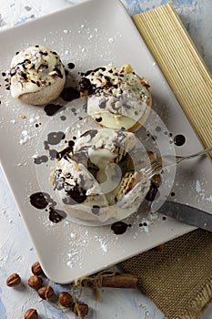 Original cinnabon rolls with chocolate-cream sauce and hazelnuts