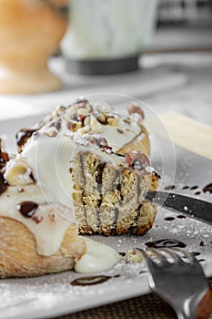 Original cinnabon rolls with chocolate-cream sauce and hazelnuts