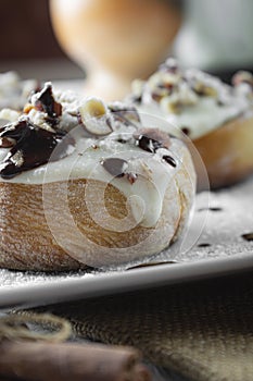 Original cinnabon rolls with chocolate-cream sauce and hazelnuts