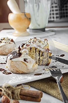 Original cinnabon rolls with chocolate-cream sauce and hazelnuts