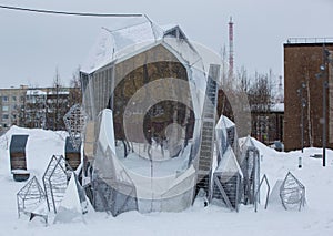 An original composition in the form of a table and chairs in the Geologists \' Square in the city of Noyabrsk in winter photo