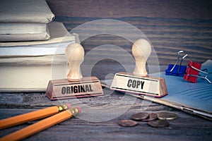 Original and Copy concept. Rubber Stamp on desk in the Office. Business and work background