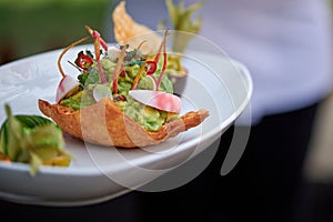 Original dish with avocado papaya mango cherry tomatoes and mint leaves