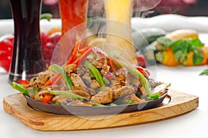 Original fajita sizzling hot on iron plate