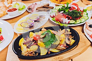 Original fajita sizzling smoking hot served on iron plate and fresh vegetables on background.