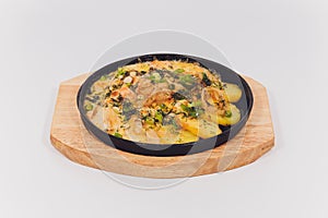 Original fajita sizzling smoking hot served on iron plate and fresh vegetables on background.